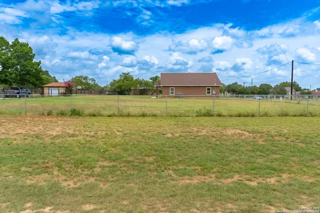 a view of a lake with a house in the background