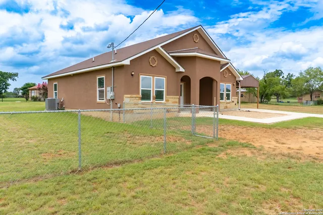 a front view of house with yard and green space