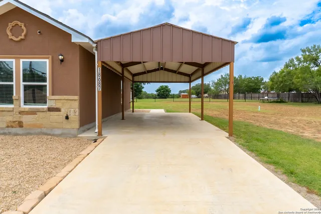 a view of a house with backyard and sitting area