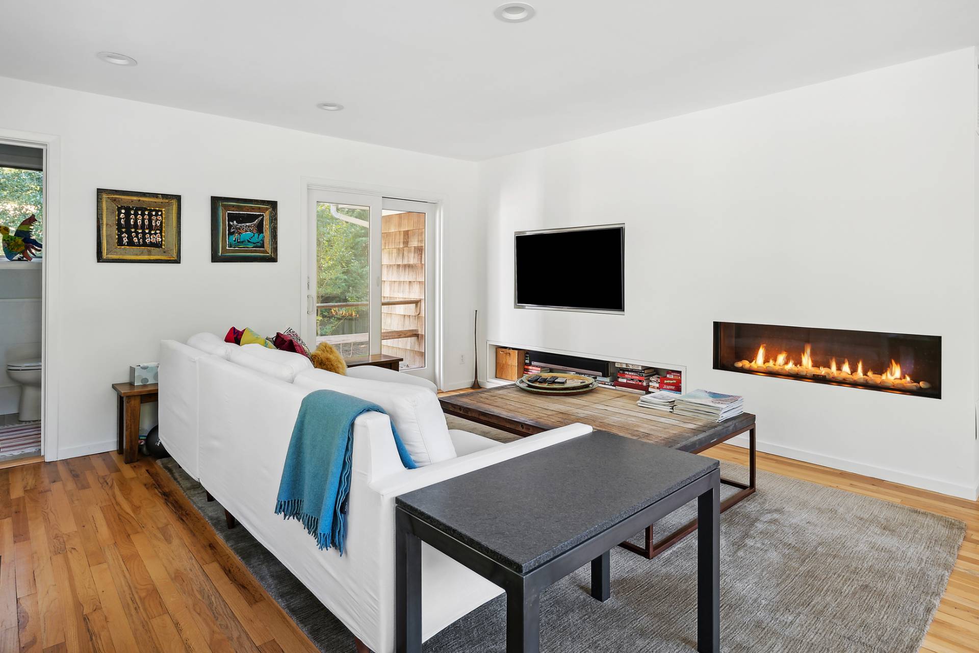 1214 Fireplace Road East Hampton, NY 11937 - Photo 4 of 19 a living room with furniture and a flat screen tv