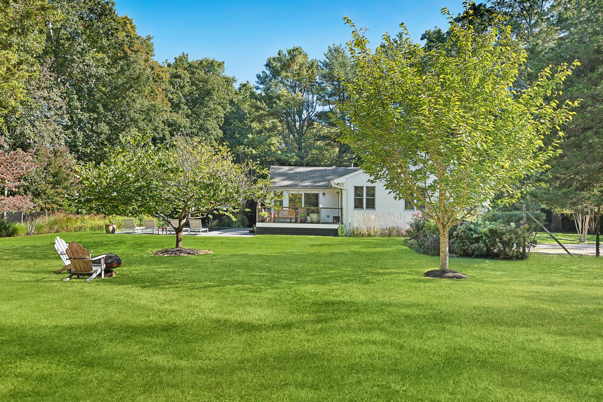 1214 Fireplace Road East Hampton, NY 11937 - Photo 5 of 19 a front view of a house with garden and trees