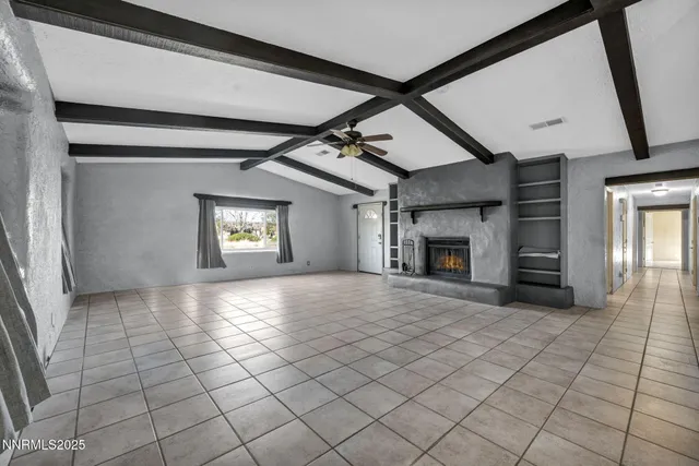 a view of an empty room and fire place