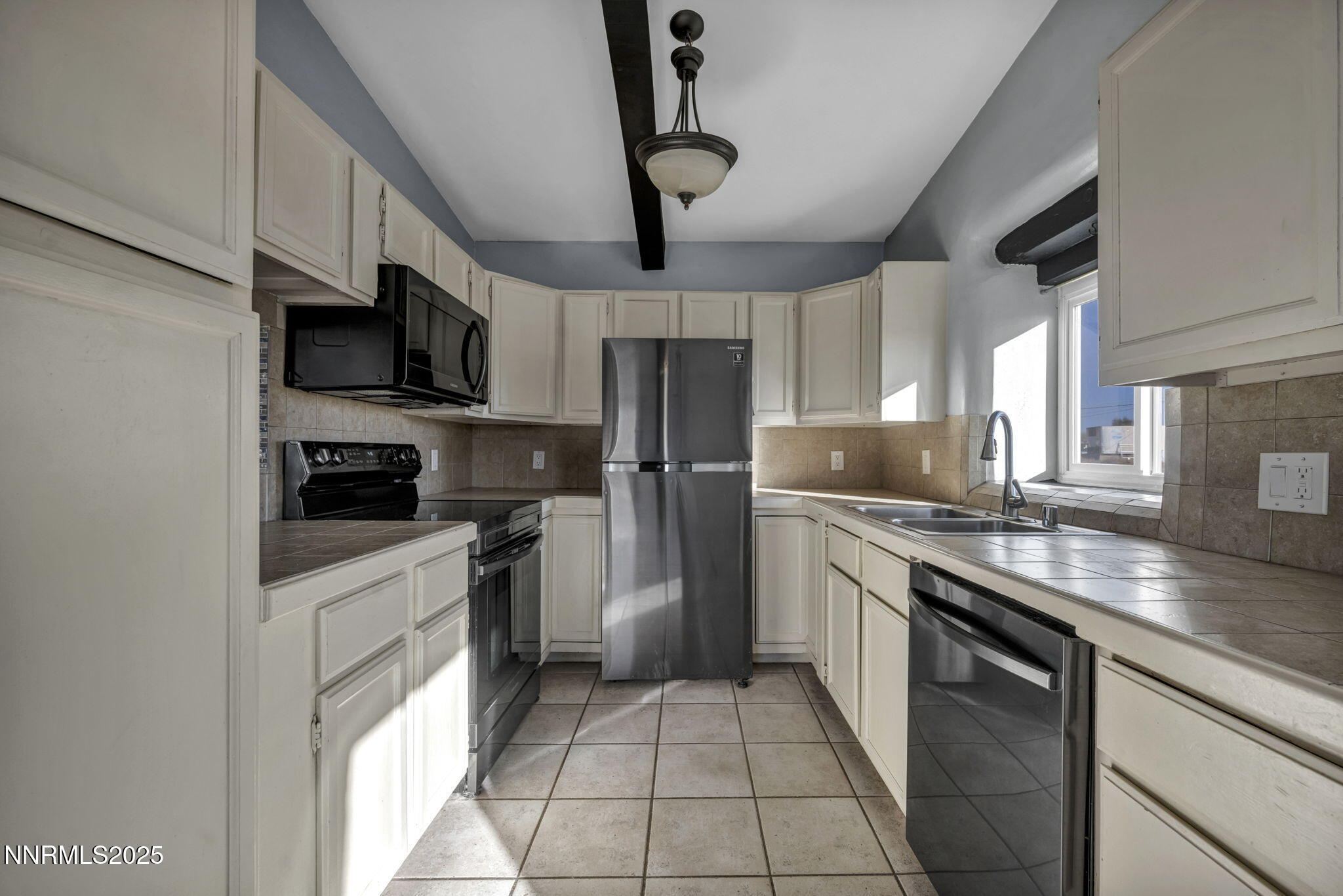 10810 Chesapeake Drive Reno, NV 89506 - Photo 14 of 34 a kitchen with stainless steel appliances granite countertop a sink a stove top oven a counter space and cabinets