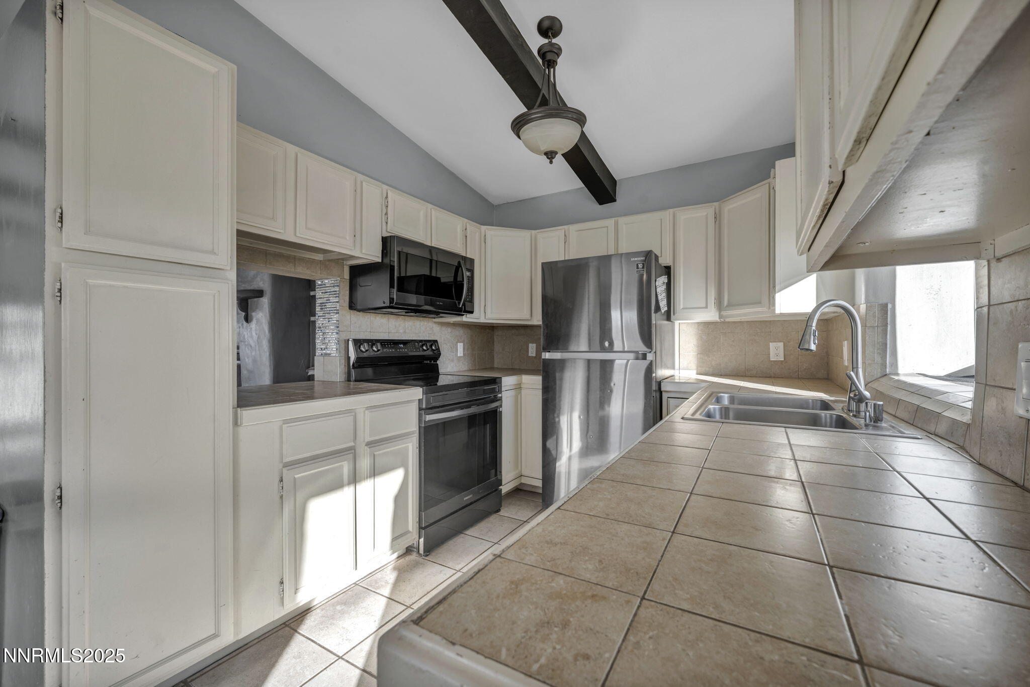 10810 Chesapeake Drive Reno, NV 89506 - Photo 15 of 34 a kitchen with granite countertop a refrigerator and a stove top oven