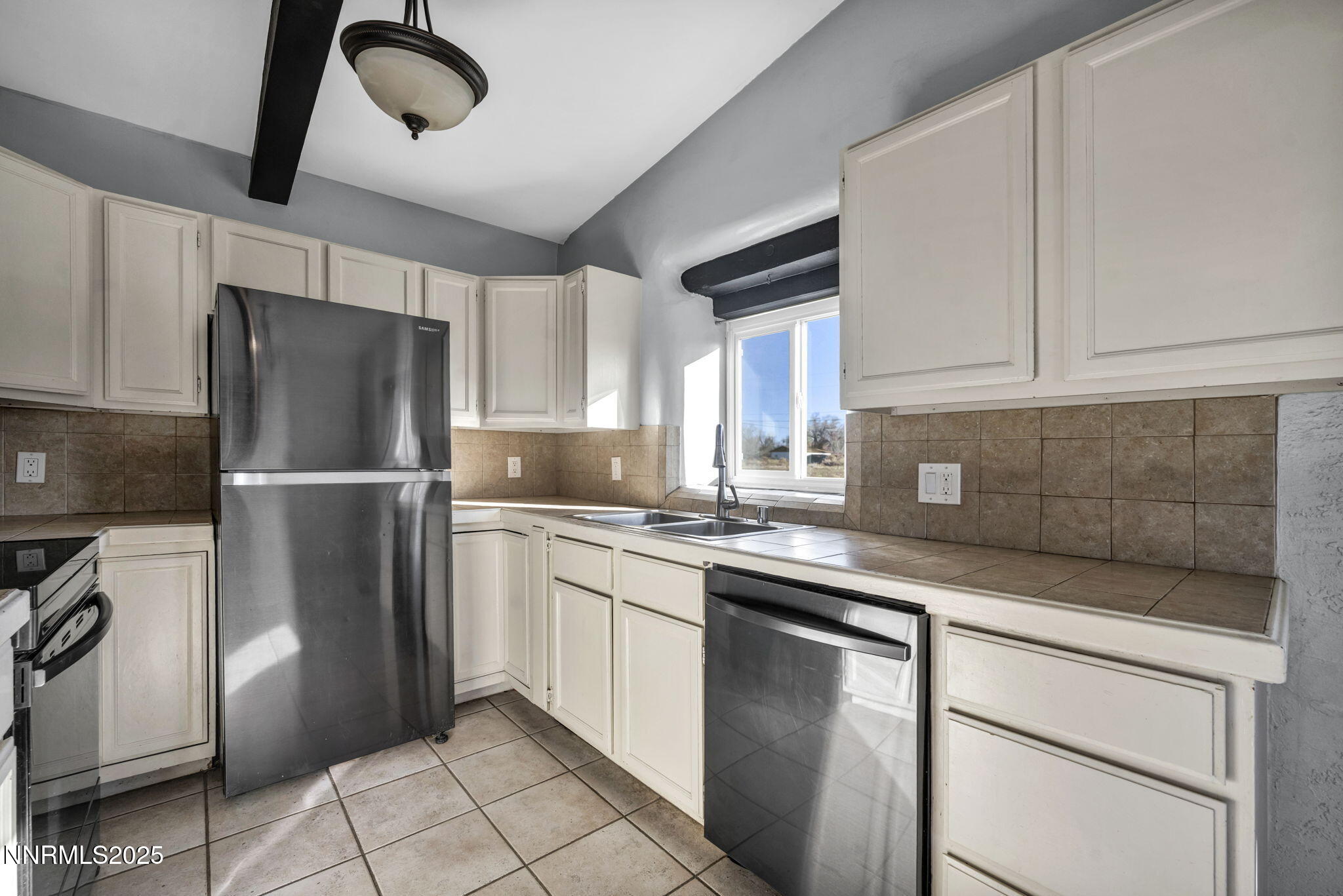 10810 Chesapeake Drive Reno, NV 89506 - Photo 16 of 34 a kitchen with a refrigerator sink and cabinets