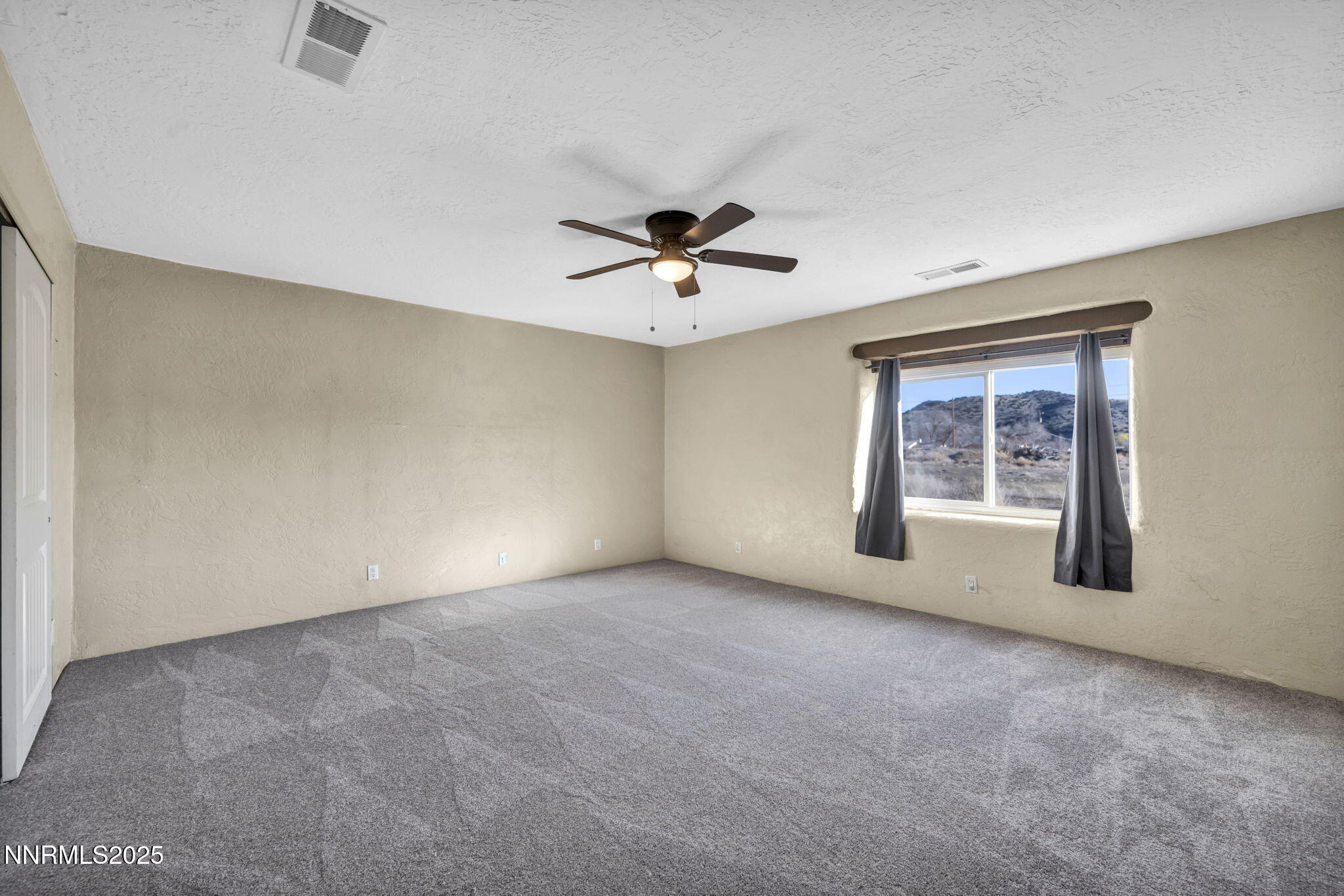 10810 Chesapeake Drive Reno, NV 89506 - Photo 18 of 34 an empty room with windows and ceiling fan