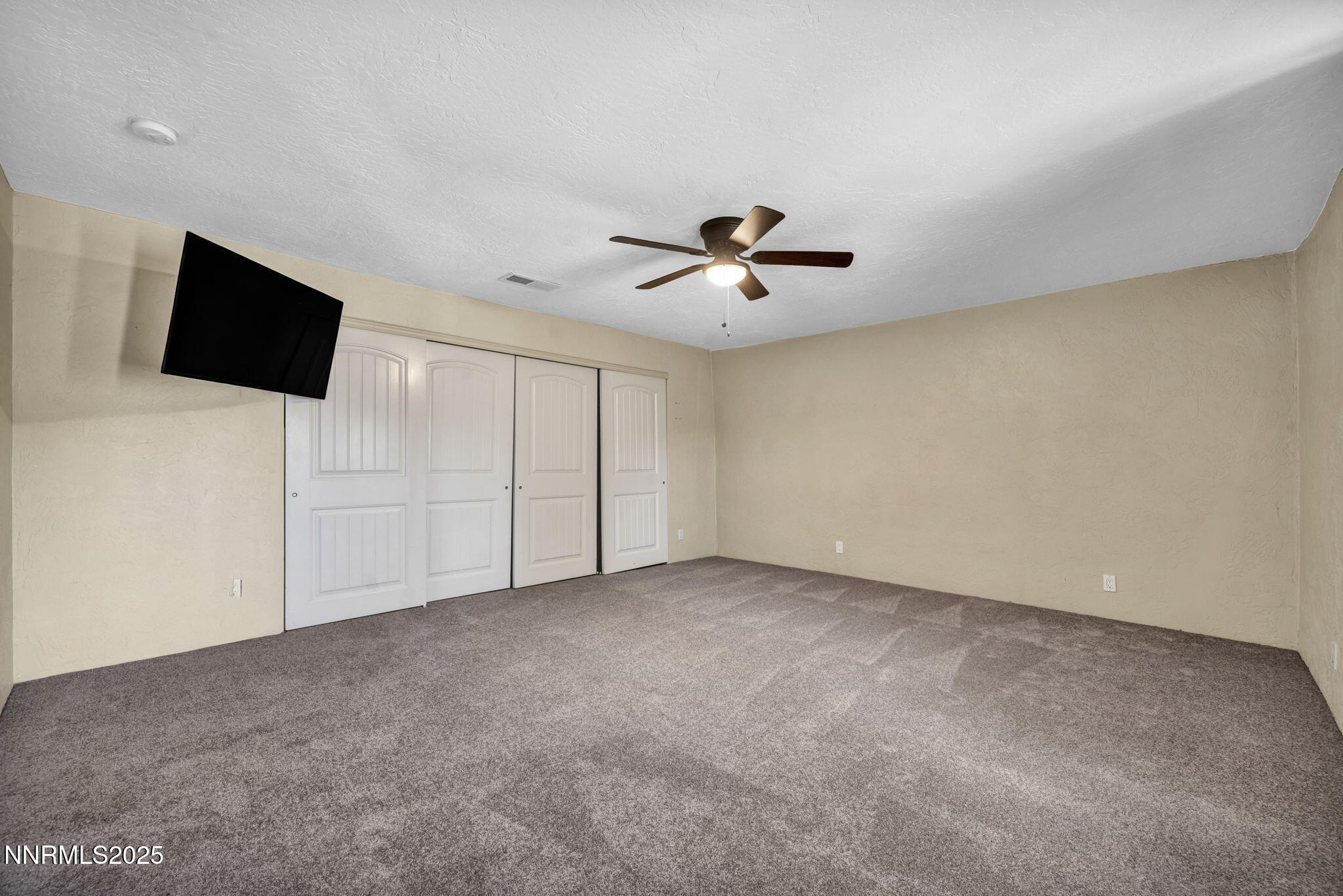 10810 Chesapeake Drive Reno, NV 89506 - Photo 20 of 34 an empty room with windows and flat screen tv