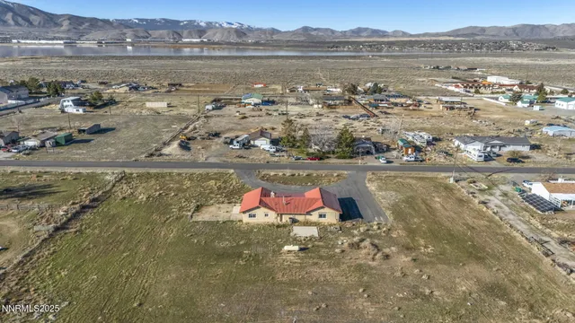 an aerial view of a houses with a yard