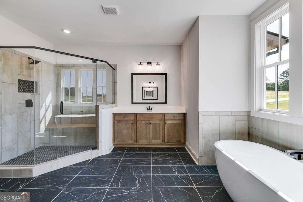 1593 Bethesda Church Road Carrollton, GA 30117 - Photo 36 of 48 a bathroom with a tub shower sink and mirror