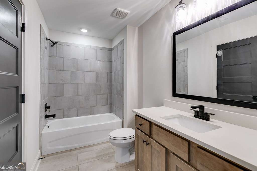 1593 Bethesda Church Road Carrollton, GA 30117 - Photo 41 of 48 a bathroom with a sink a toilet and shower