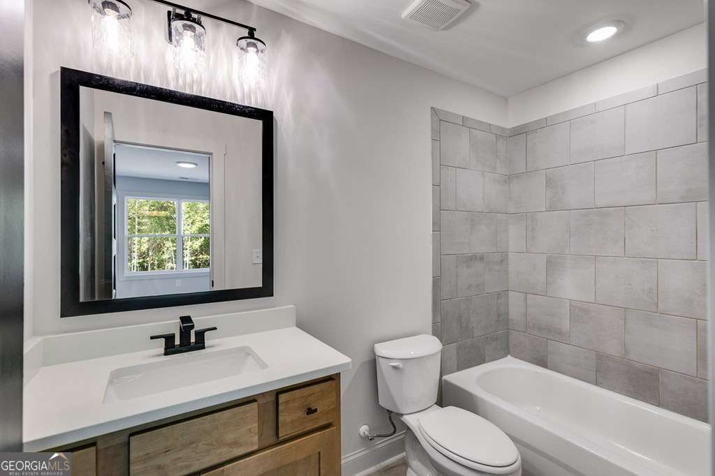 1593 Bethesda Church Road Carrollton, GA 30117 - Photo 46 of 48 a bathroom with a sink toilet and shower