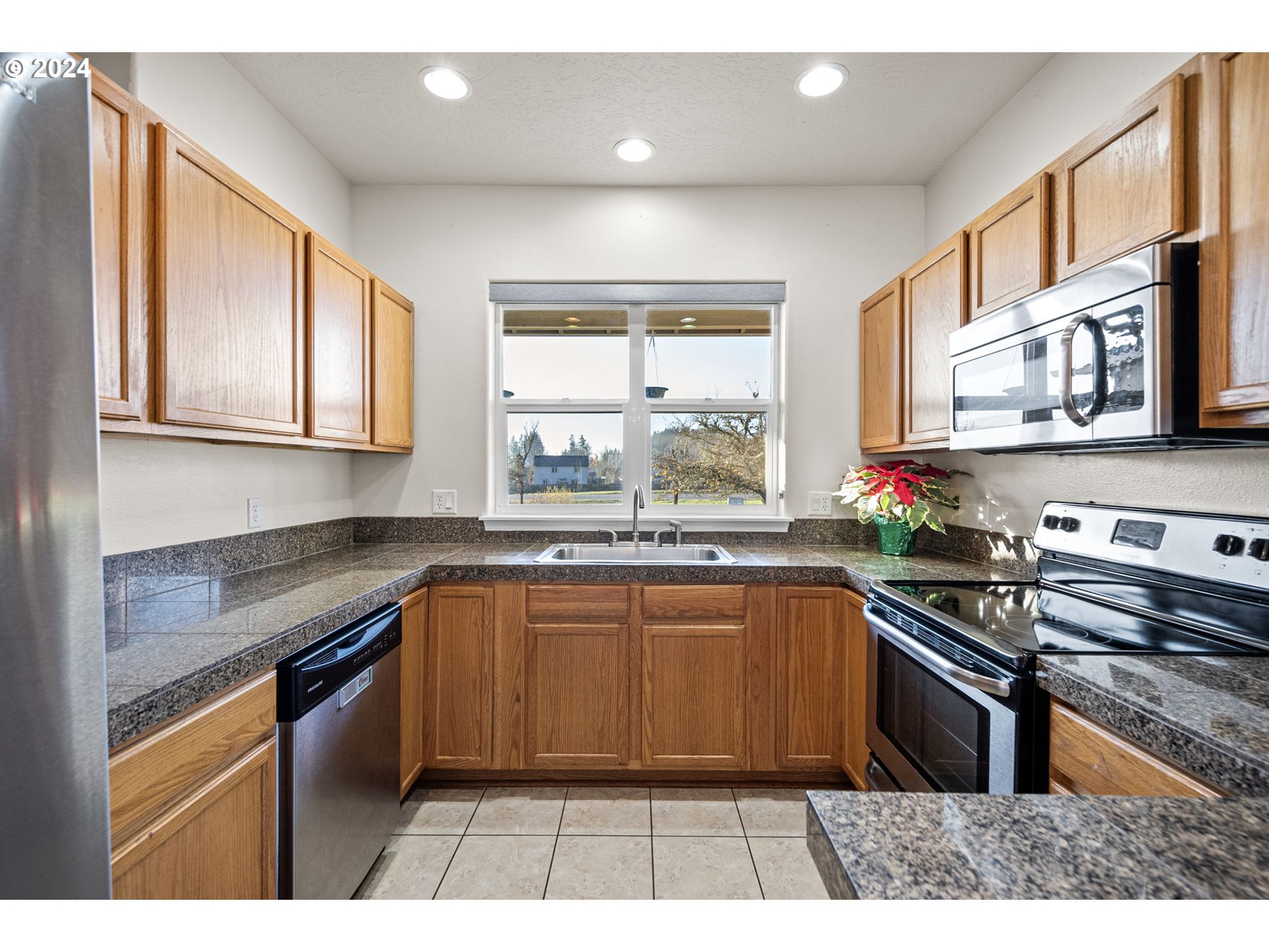 1529 South 59th Street Springfield, OR 97478 - Photo 12 of 38 a kitchen with stainless steel appliances granite countertop a sink and stove