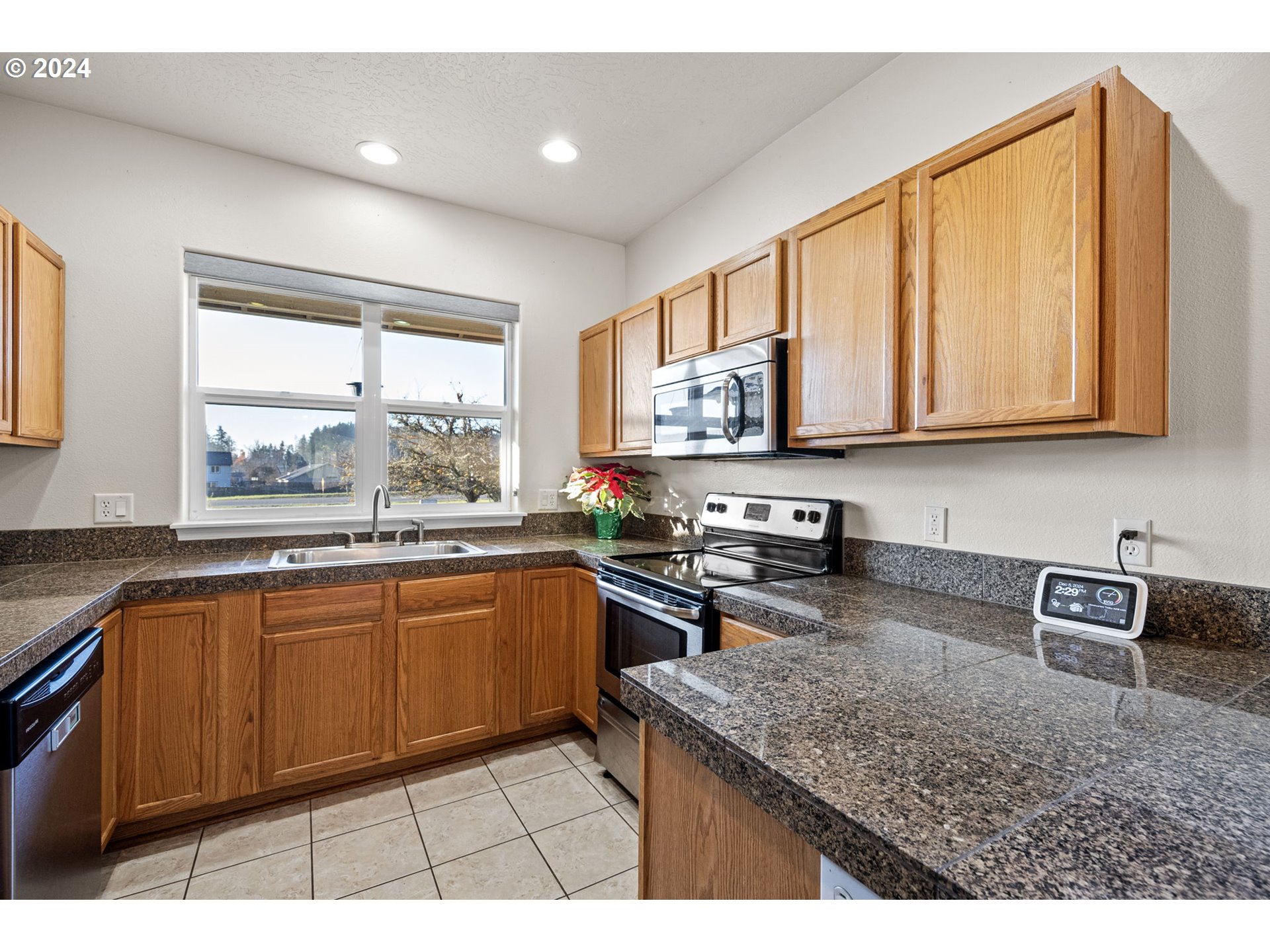 1529 South 59th Street Springfield, OR 97478 - Photo 13 of 38 a kitchen with stainless steel appliances granite countertop a stove a sink and a microwave