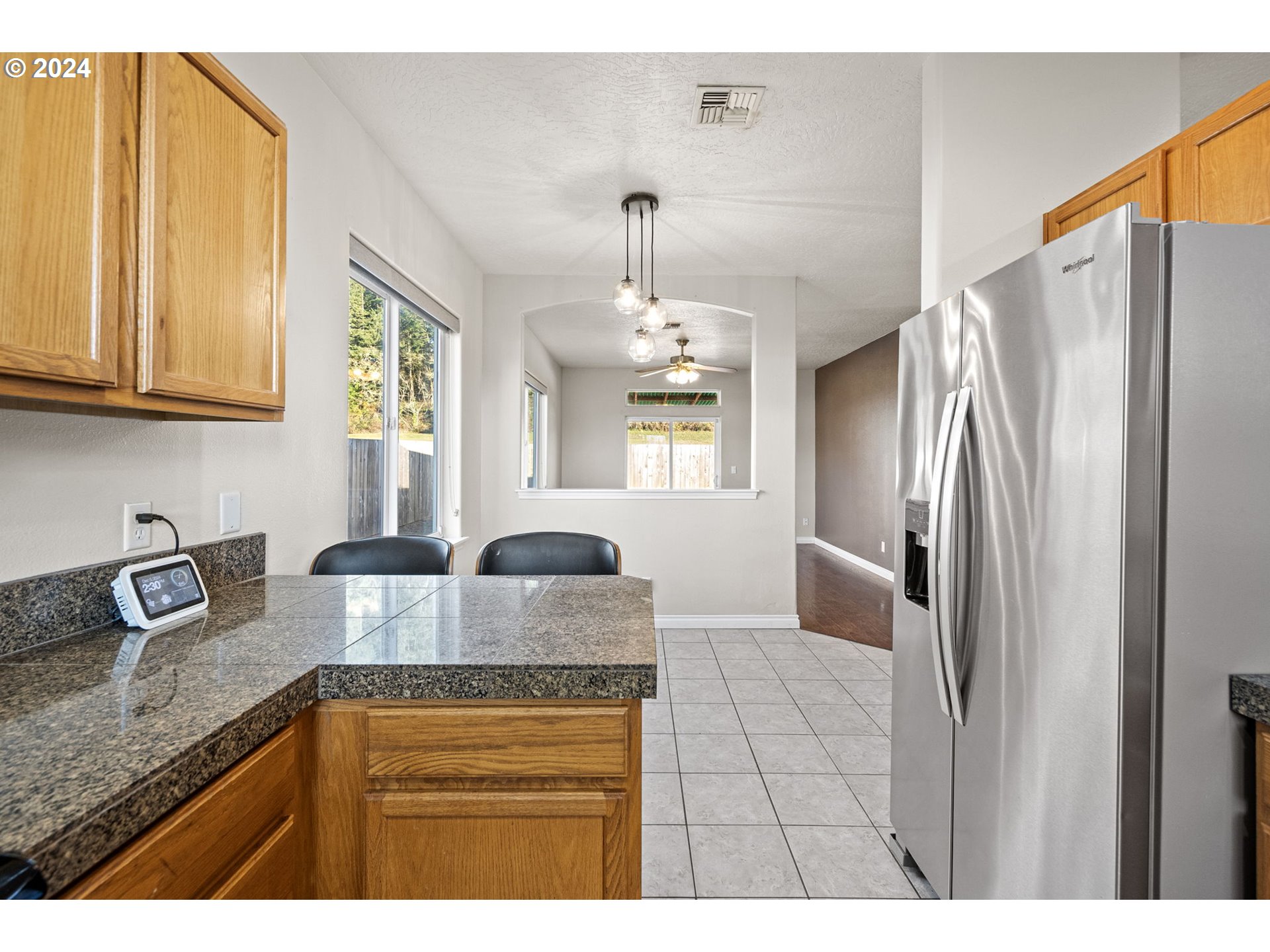 1529 South 59th Street Springfield, OR 97478 - Photo 15 of 38 a kitchen with granite countertop a sink a counter top space cabinets and stainless steel appliances