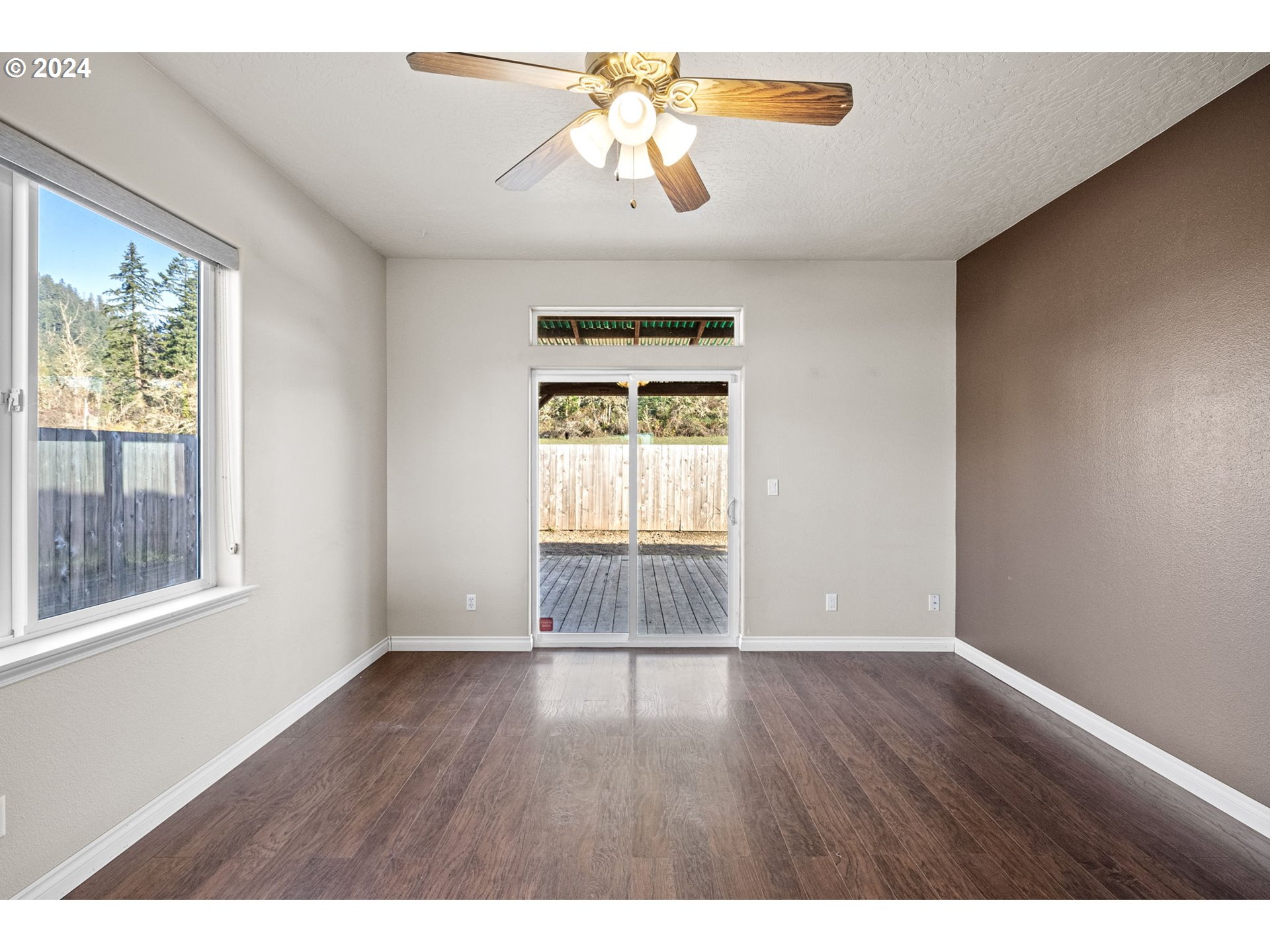 1529 South 59th Street Springfield, OR 97478 - Photo 17 of 38 a view of an empty room with window and wooden floor
