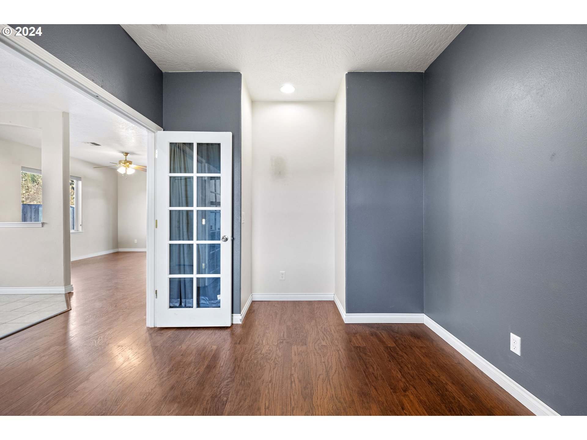 1529 South 59th Street Springfield, OR 97478 - Photo 7 of 38 a view of an empty room with wooden floor and a window