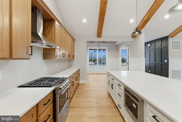 a kitchen with a refrigerator sink and cabinets
