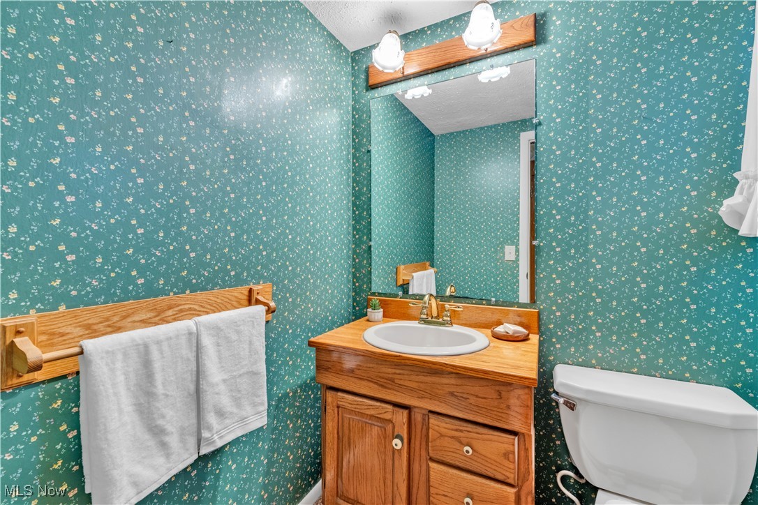506 Logan Road Mansfield, OH 44907 - Photo 24 of 46 Half bathroom featuring vanity and wallpapered walls