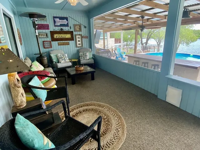 a living room with furniture and a floor to ceiling window