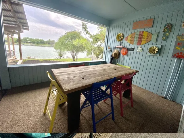 a view of a dining table and chairs in the balcony