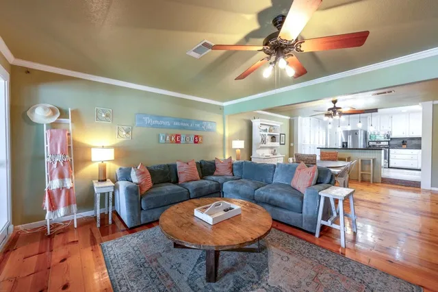 a living room with furniture and a chandelier