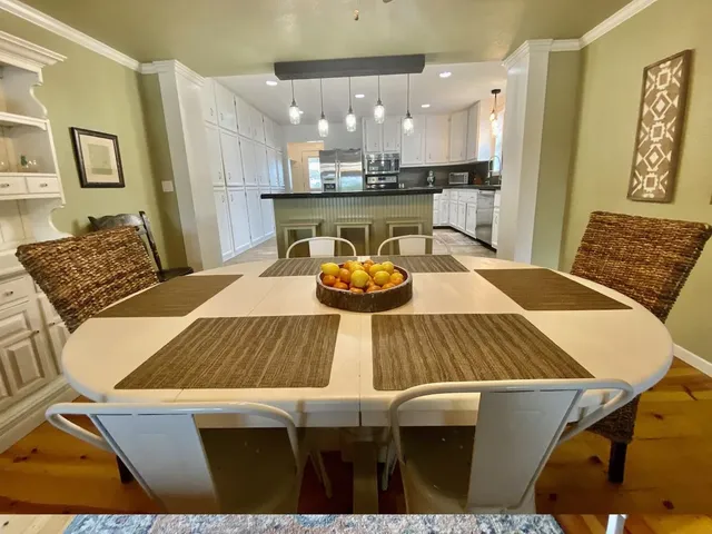 a view of a dining room with furniture and wooden floor