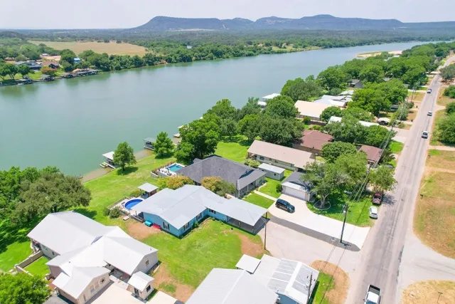an aerial view of a house with garden space and lake view