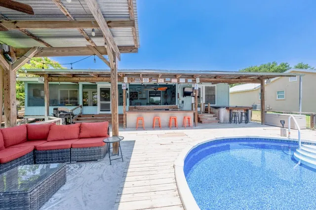 a view of a patio with swimming pool table and chairs
