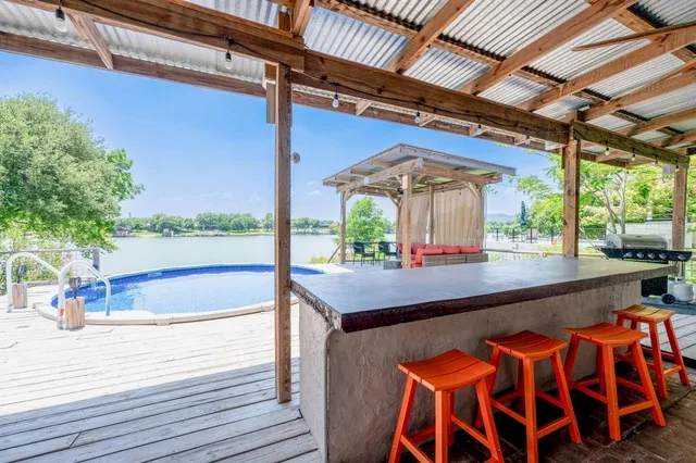 a view of a patio with a table and chairs