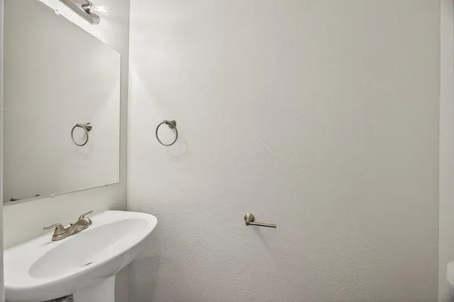 a bathroom with a sink and mirror