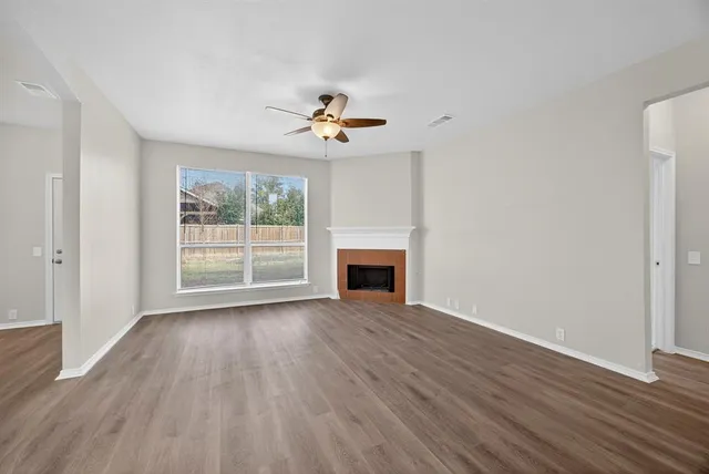 a view of a room with wooden floors and fireplace