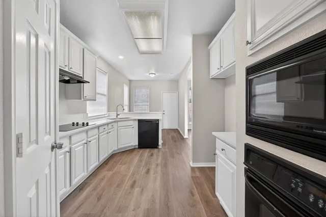 a large kitchen with stainless steel appliances and cabinets