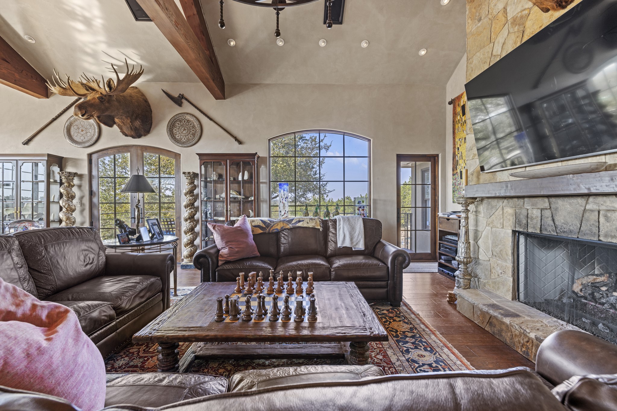 5801 Mount Gainor Road Wimberley, TX 78676 - Photo 12 of 40 a living room with furniture fireplace and a flat screen tv