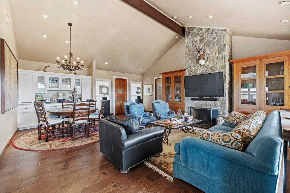 5801 Mount Gainor Road Wimberley, TX 78676 - Photo 15 of 40 Living area with dark wood-style floors, a chandelier, recessed lighting, and a fireplace