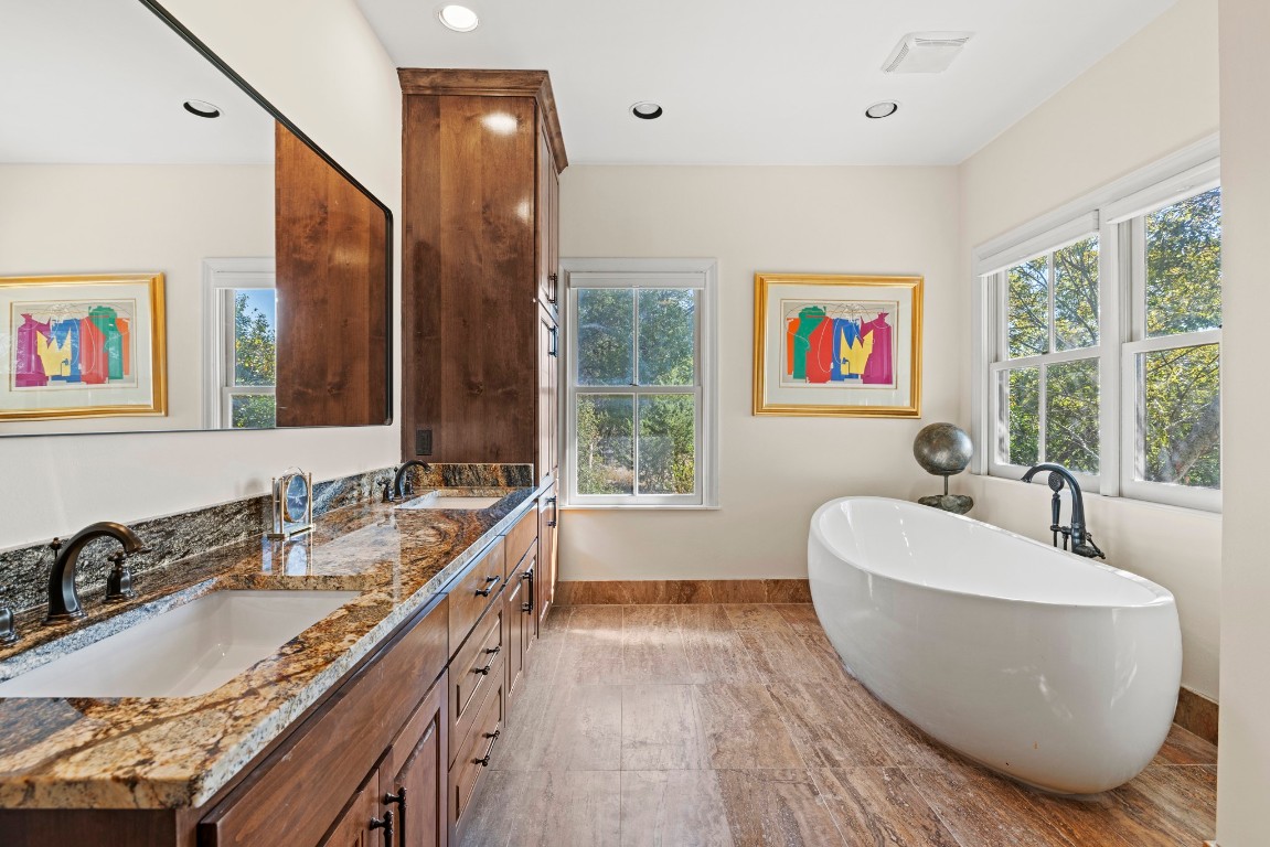 5801 Mount Gainor Road Wimberley, TX 78676 - Photo 19 of 40 Full bath with double vanity, a freestanding bath, and recessed lighting