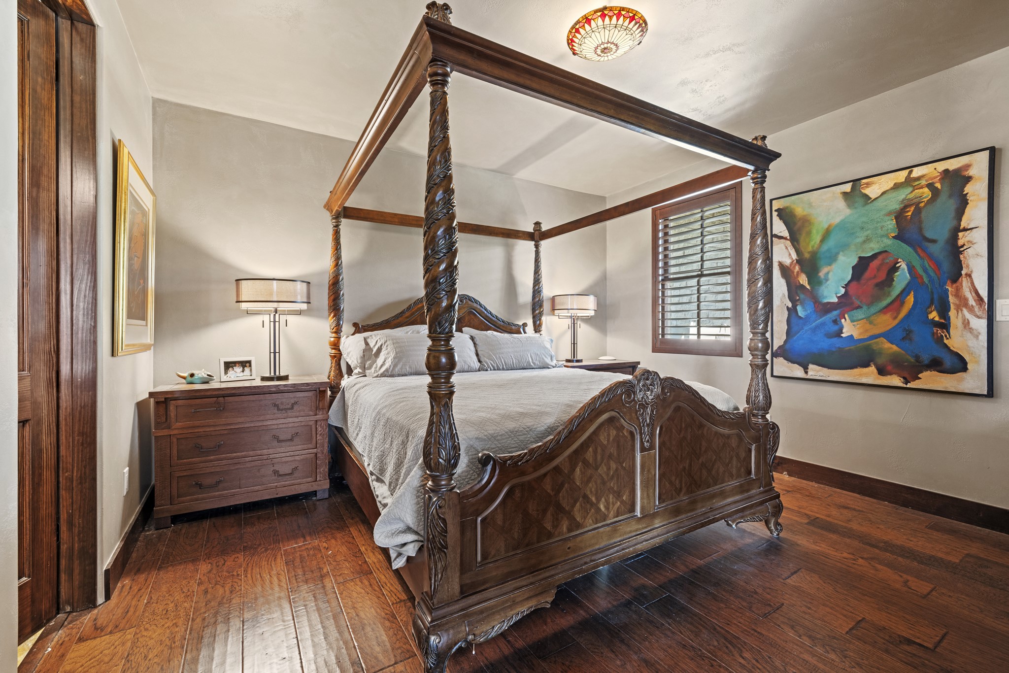 5801 Mount Gainor Road Wimberley, TX 78676 - Photo 20 of 40 a bed room with a bed and a painting on the wall