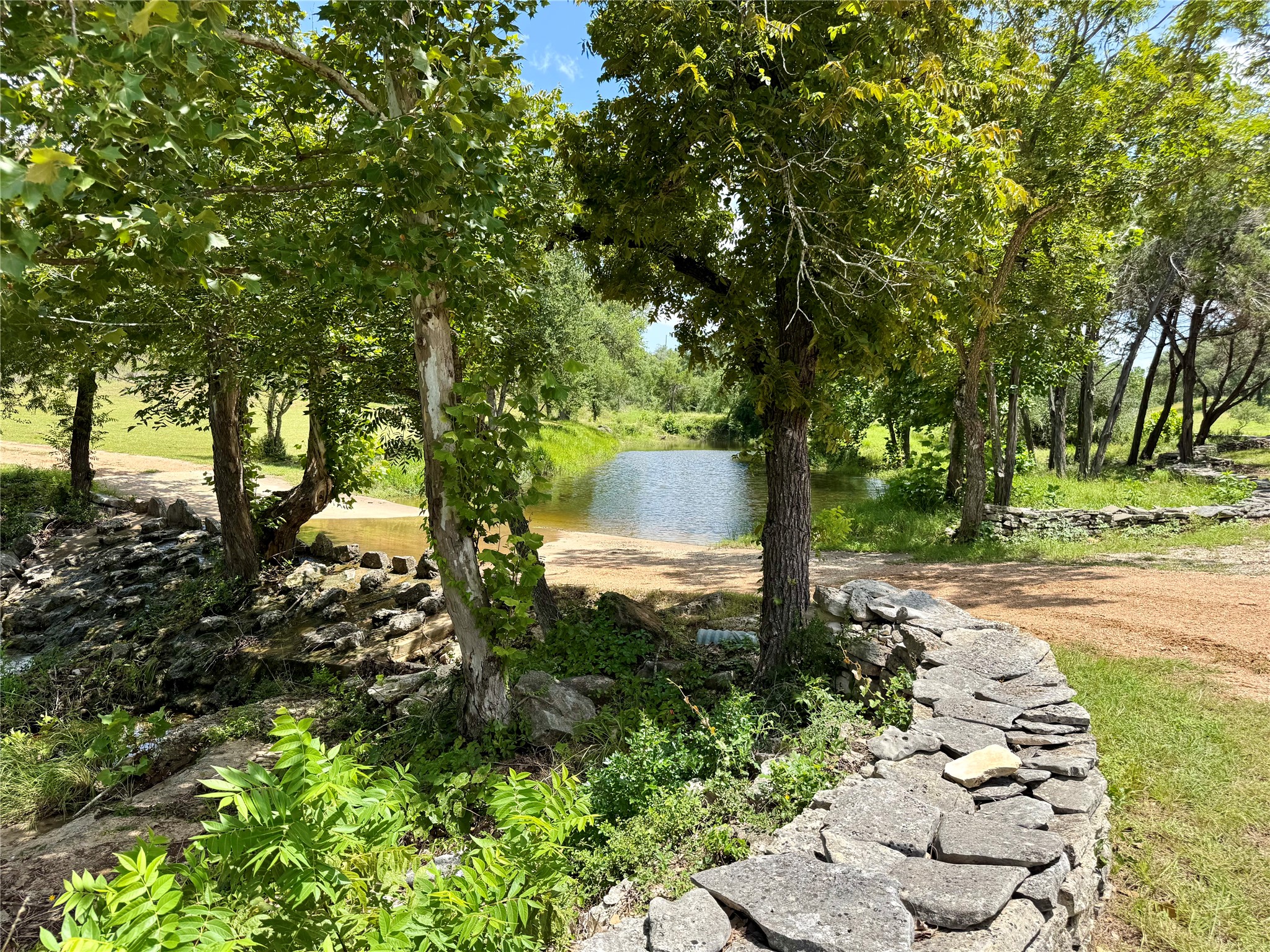 5801 Mount Gainor Road Wimberley, TX 78676 - Photo 2 of 40 a backyard of a house with lots of green space