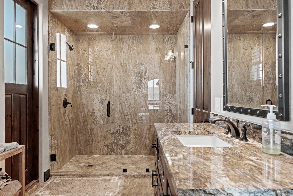 5801 Mount Gainor Road Wimberley, TX 78676 - Photo 21 of 40 Bathroom with vanity and a stall shower