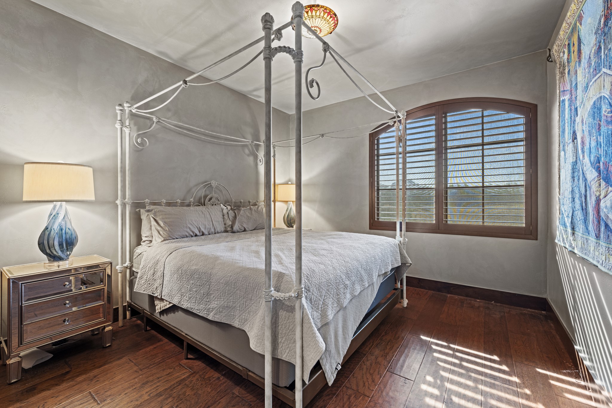 5801 Mount Gainor Road Wimberley, TX 78676 - Photo 22 of 40 a bedroom with a bed and wooden floor