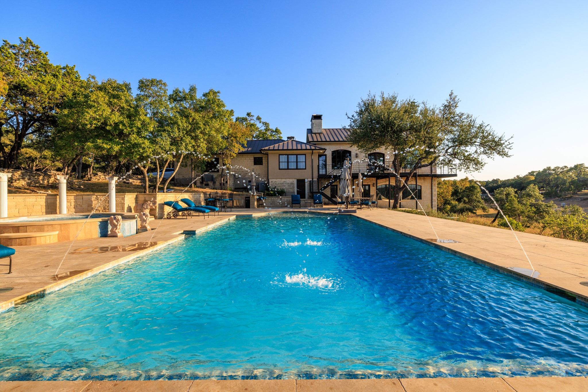5801 Mount Gainor Road Wimberley, TX 78676 - Photo 4 of 40 a view of a house with pool and a yard