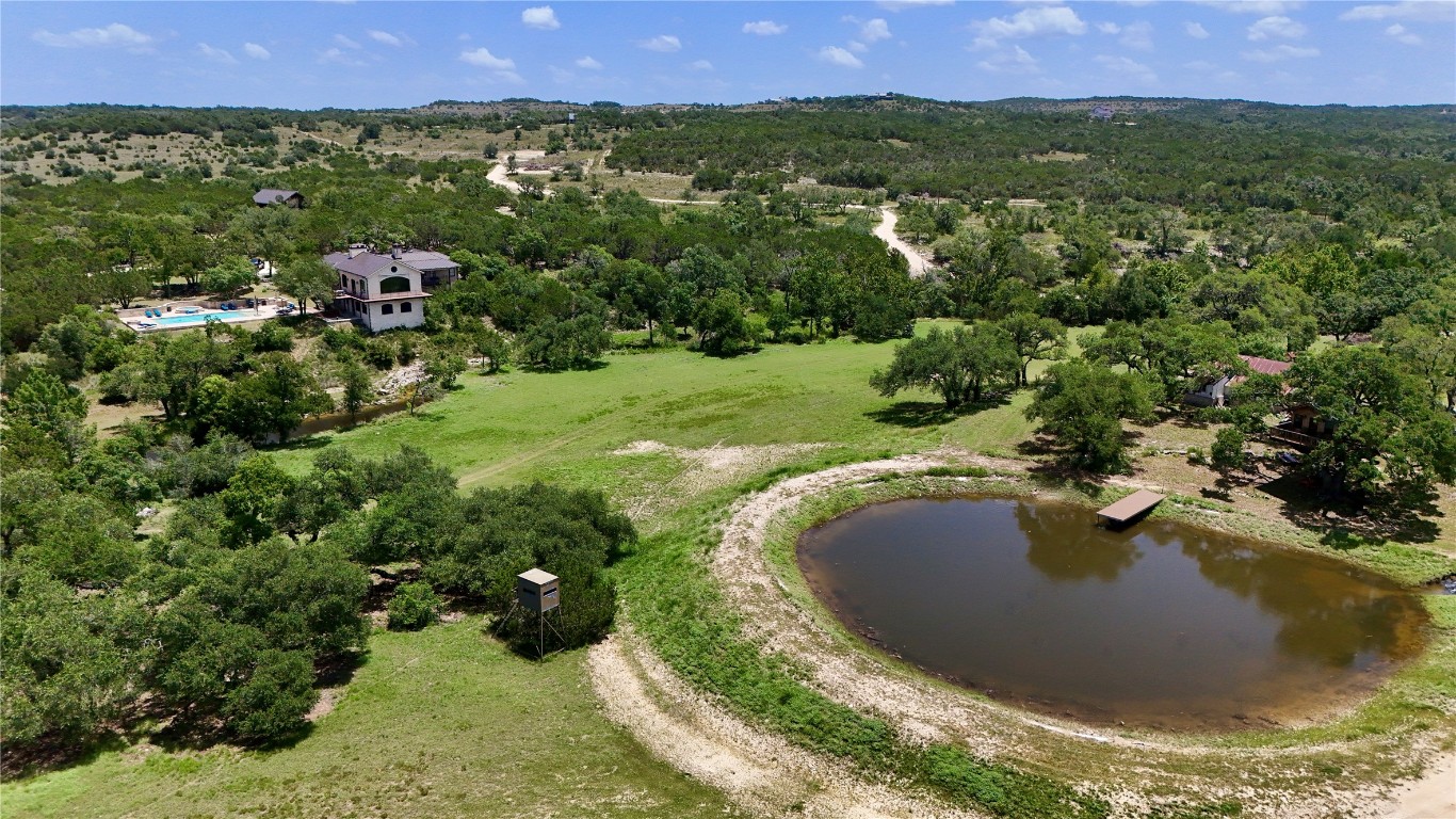 5801 Mount Gainor Road Wimberley, TX 78676 - Photo 6 of 40 Drone / aerial view of a heavily wooded area and a large body of water