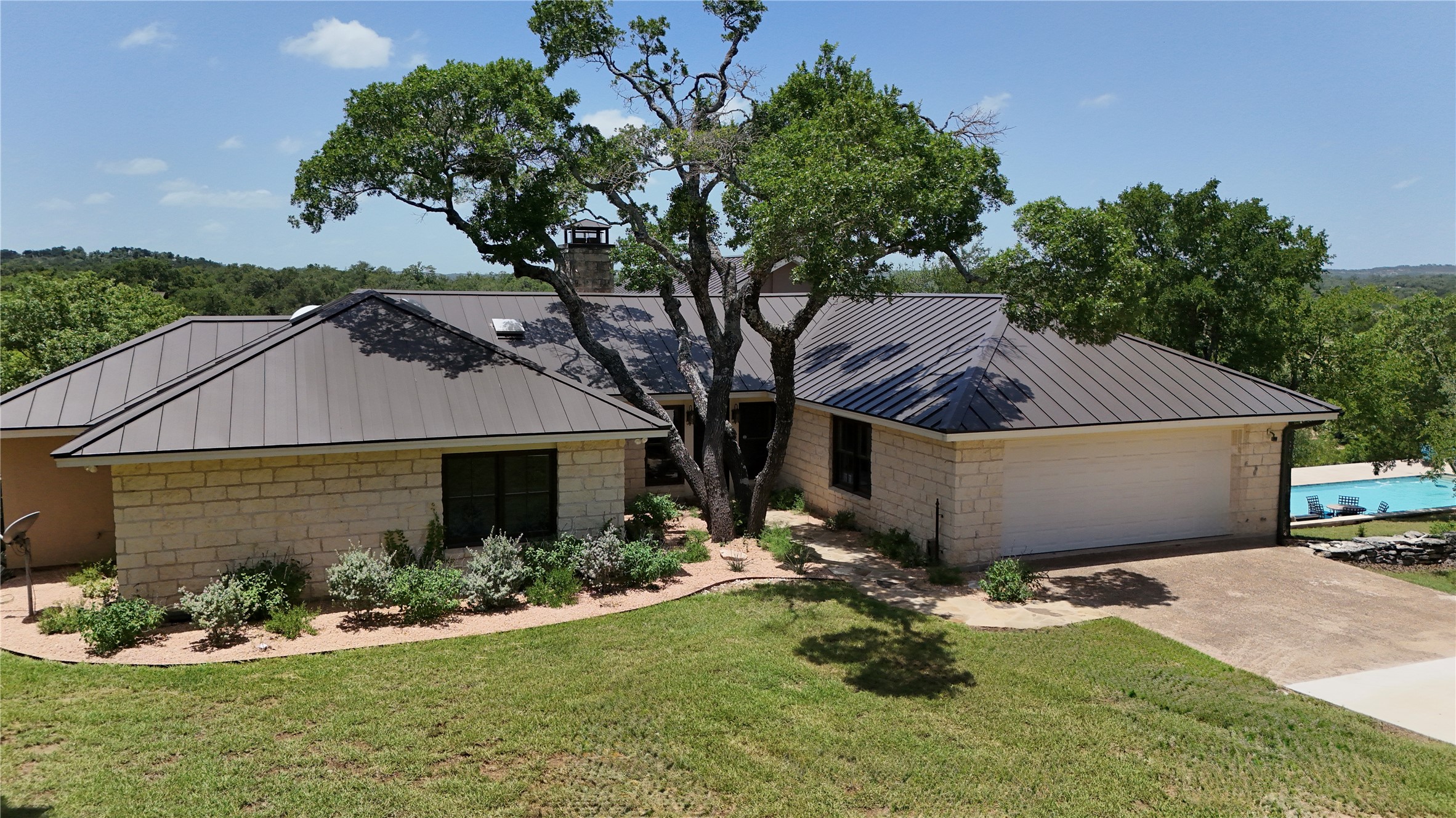 5801 Mount Gainor Road Wimberley, TX 78676 - Photo 8 of 40 a house view with a garden space