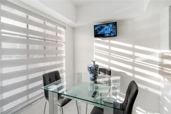 a kitchen with a sink stainless steel appliances and white cabinets