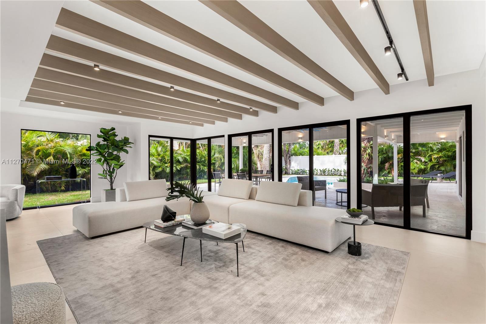 4095 Battersea Road Miami, FL 33133 - Photo 1 of 40 a living room with furniture and a large window
