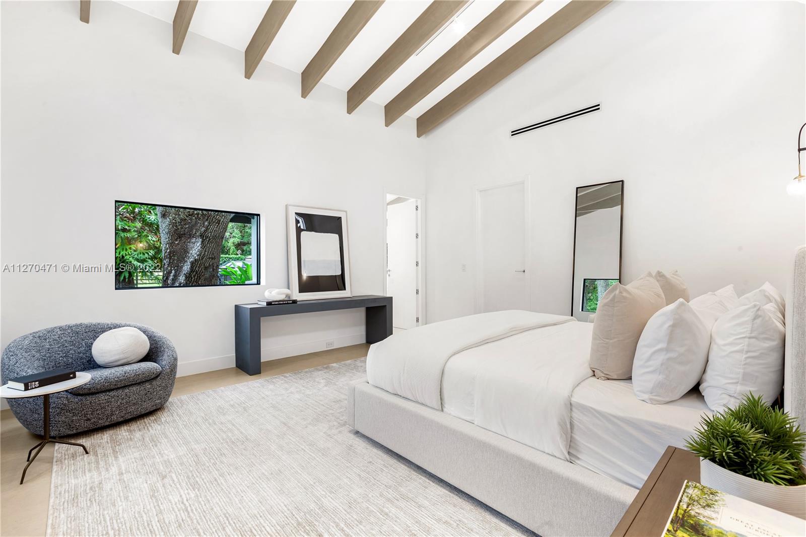 4095 Battersea Road Miami, FL 33133 - Photo 13 of 40 a bedroom with a bed and a couch