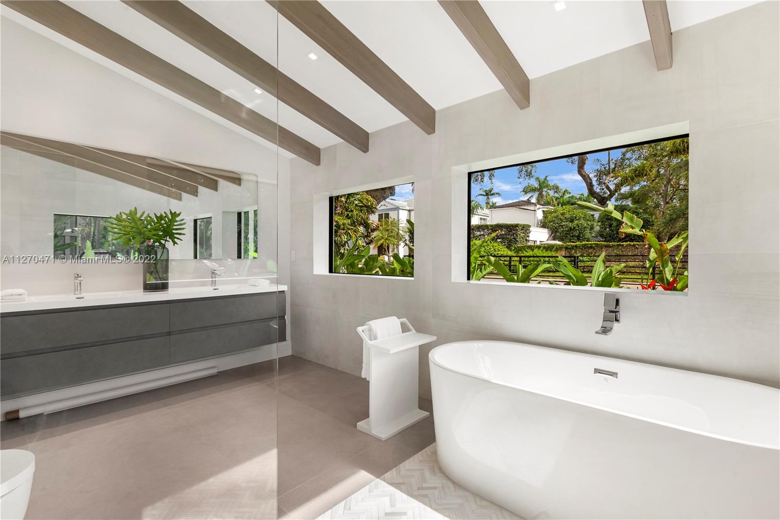 4095 Battersea Road Miami, FL 33133 - Photo 15 of 40 a bathroom with a bathtub and a sink
