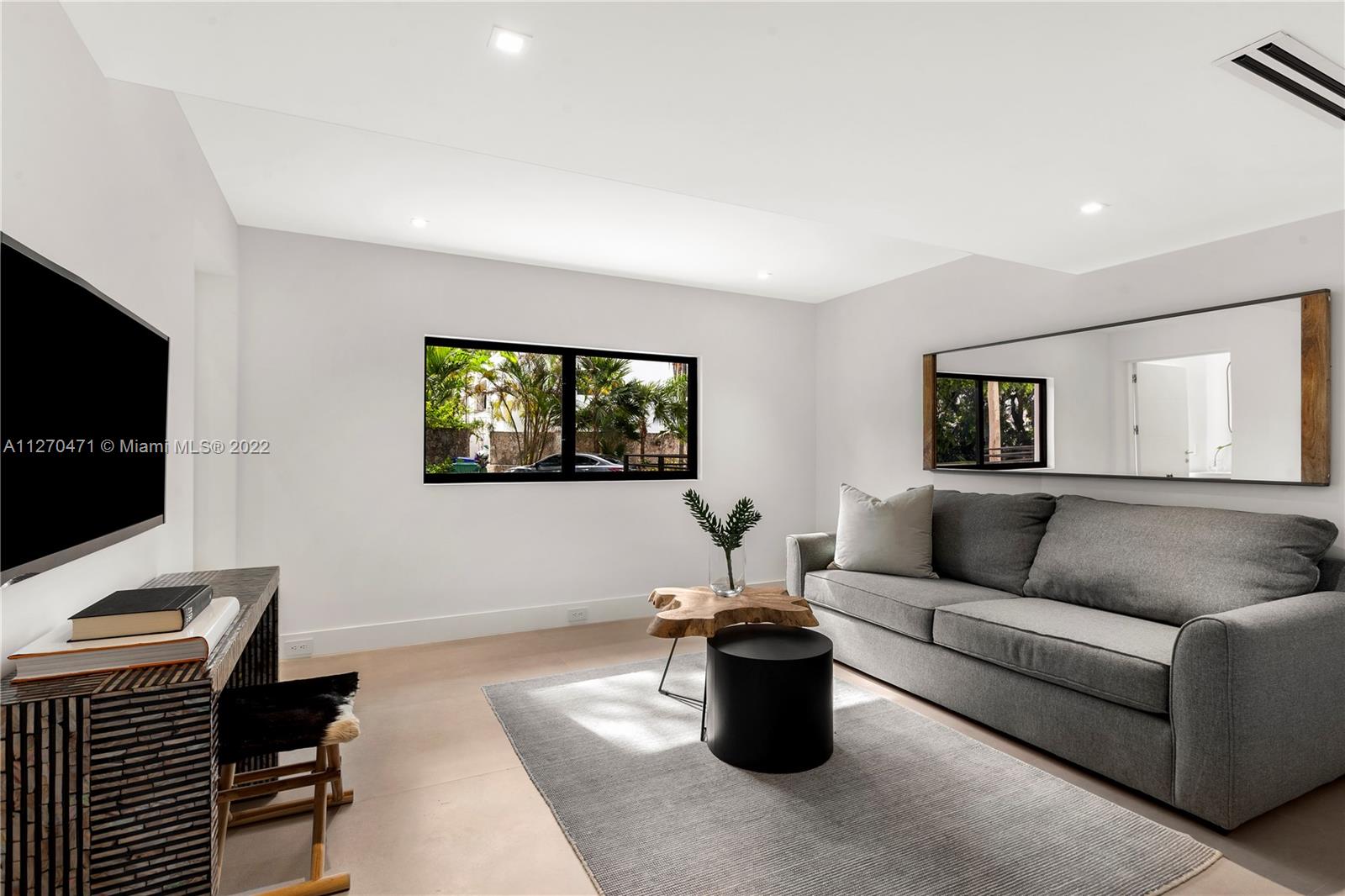 4095 Battersea Road Miami, FL 33133 - Photo 17 of 40 a living room with furniture and a flat screen tv
