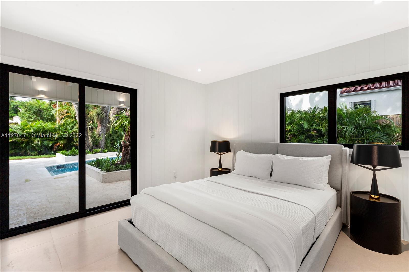 4095 Battersea Road Miami, FL 33133 - Photo 19 of 40 a bedroom with a bed and a large window