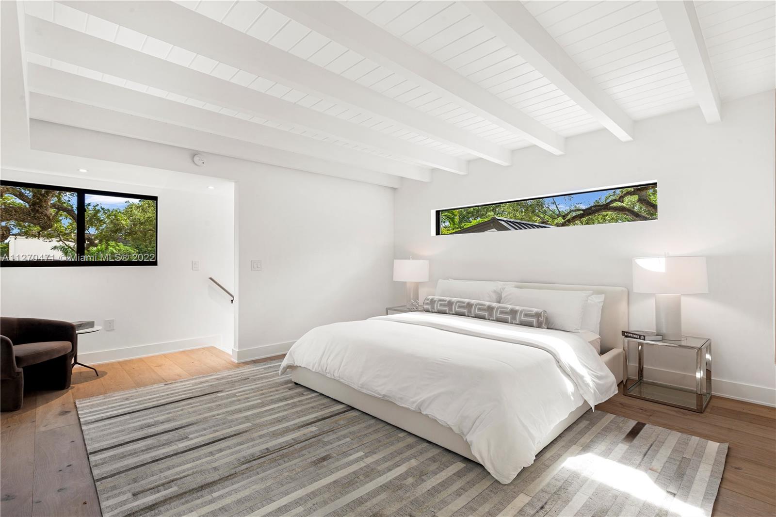 4095 Battersea Road Miami, FL 33133 - Photo 24 of 40 a bedroom with a bed and a flat screen tv