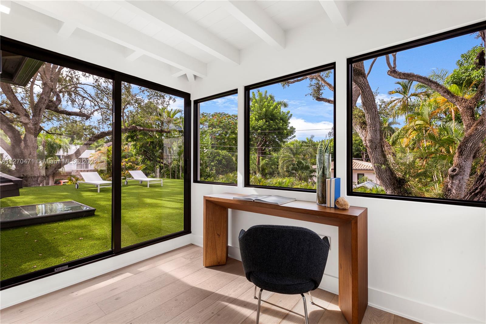 4095 Battersea Road Miami, FL 33133 - Photo 25 of 40 a living room with large window and a table